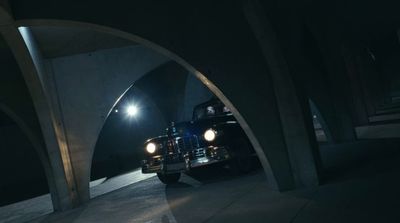 a truck driving through a tunnel at night