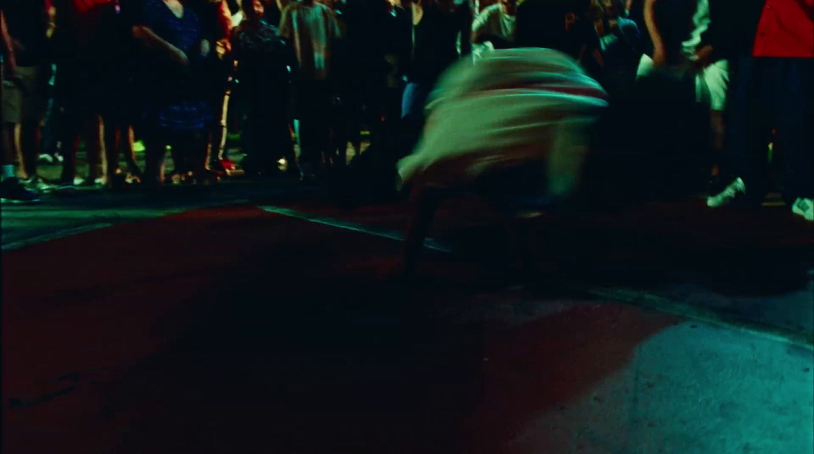 a crowd of people watching a person on a skateboard