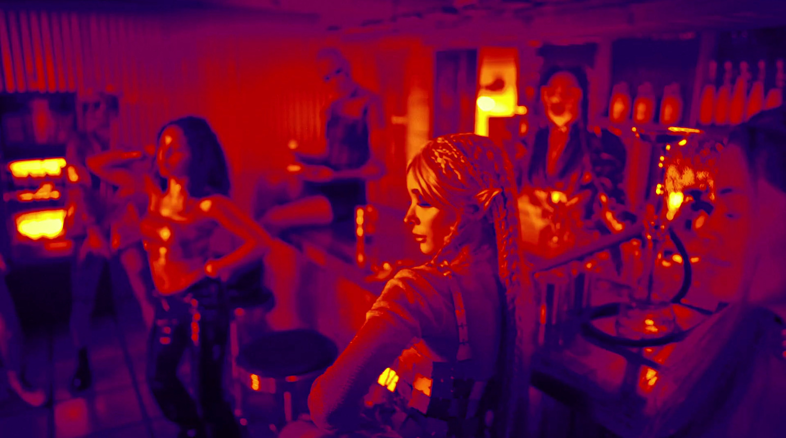 a group of people in a room with red lights