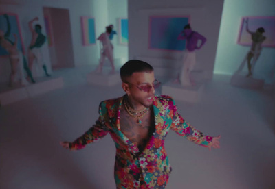 a man in a colorful suit standing in a room