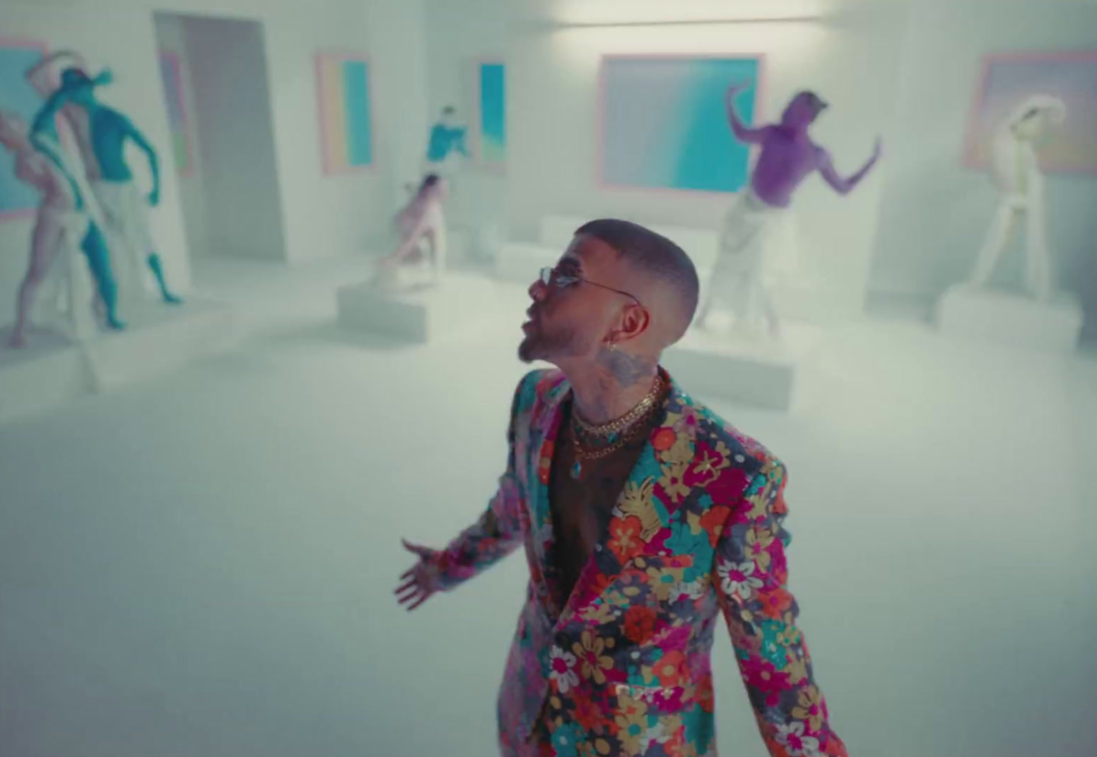 a man in a colorful suit standing in a room