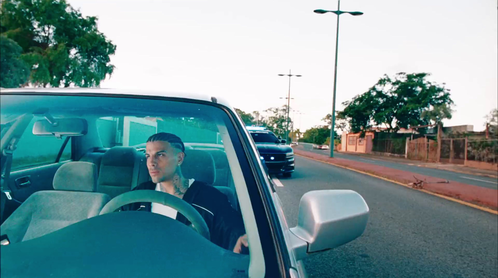 a man driving a car down a street