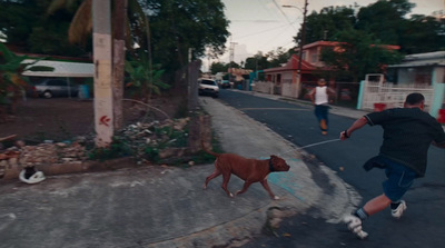 a man running down a street with a dog on a leash