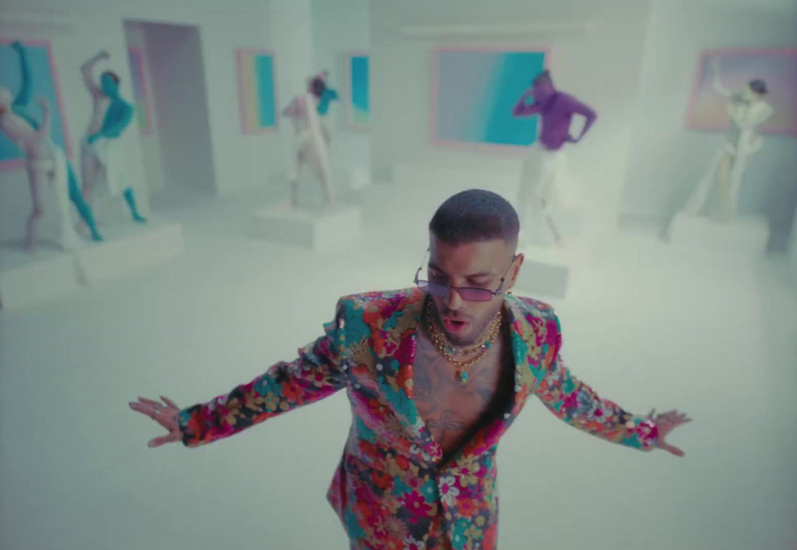 a man in a brightly colored suit is dancing