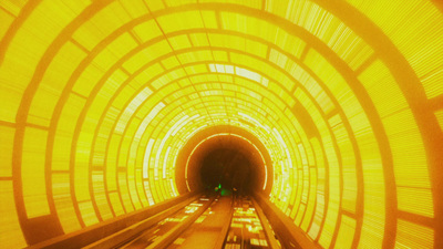 a train traveling through a tunnel filled with yellow lights