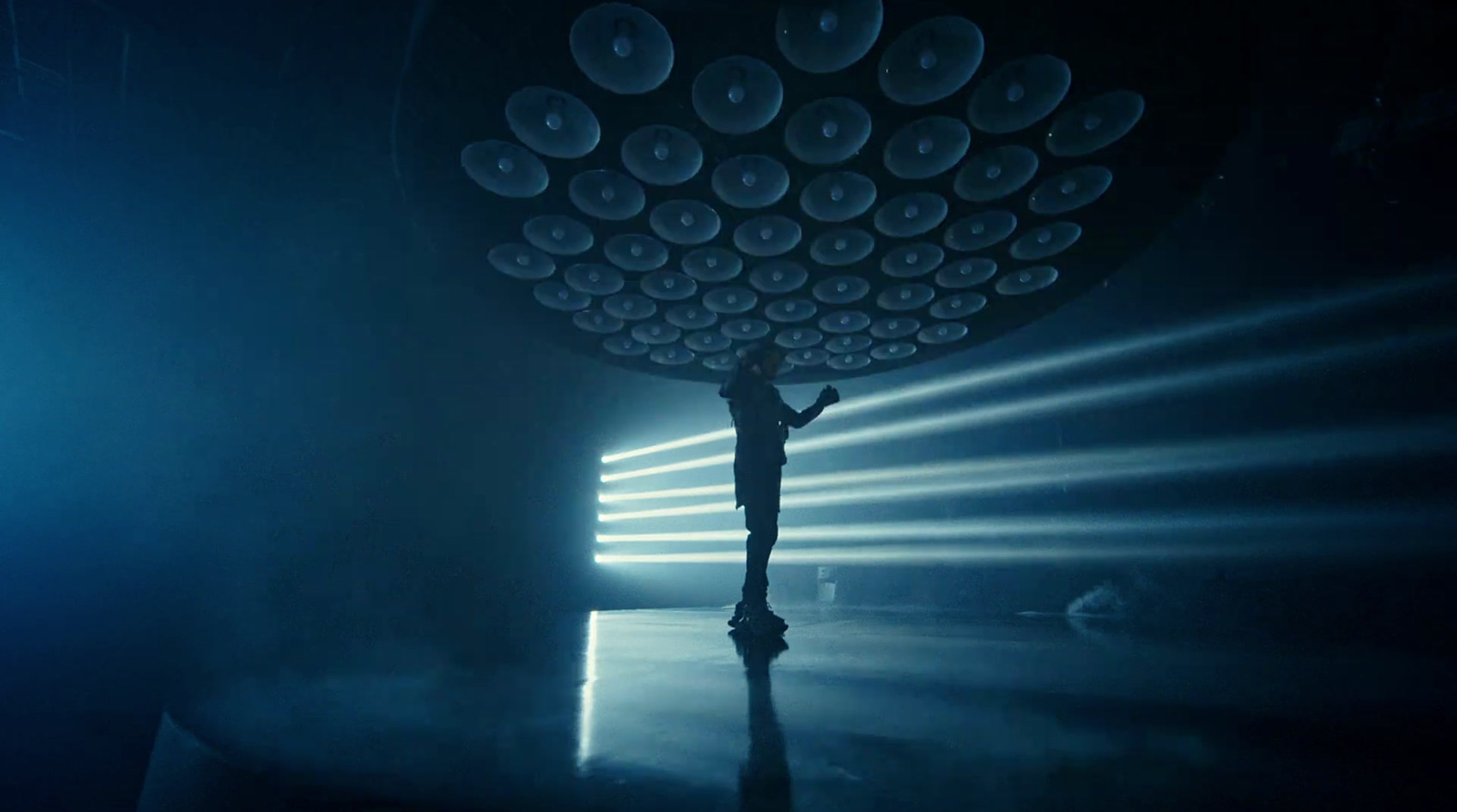 a person standing in a dark room with lights