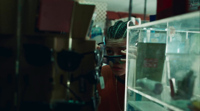 a young girl looking through a glass case in a store