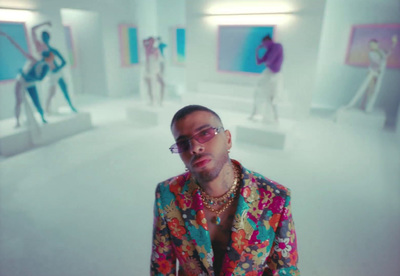 a man in a colorful suit standing in a room