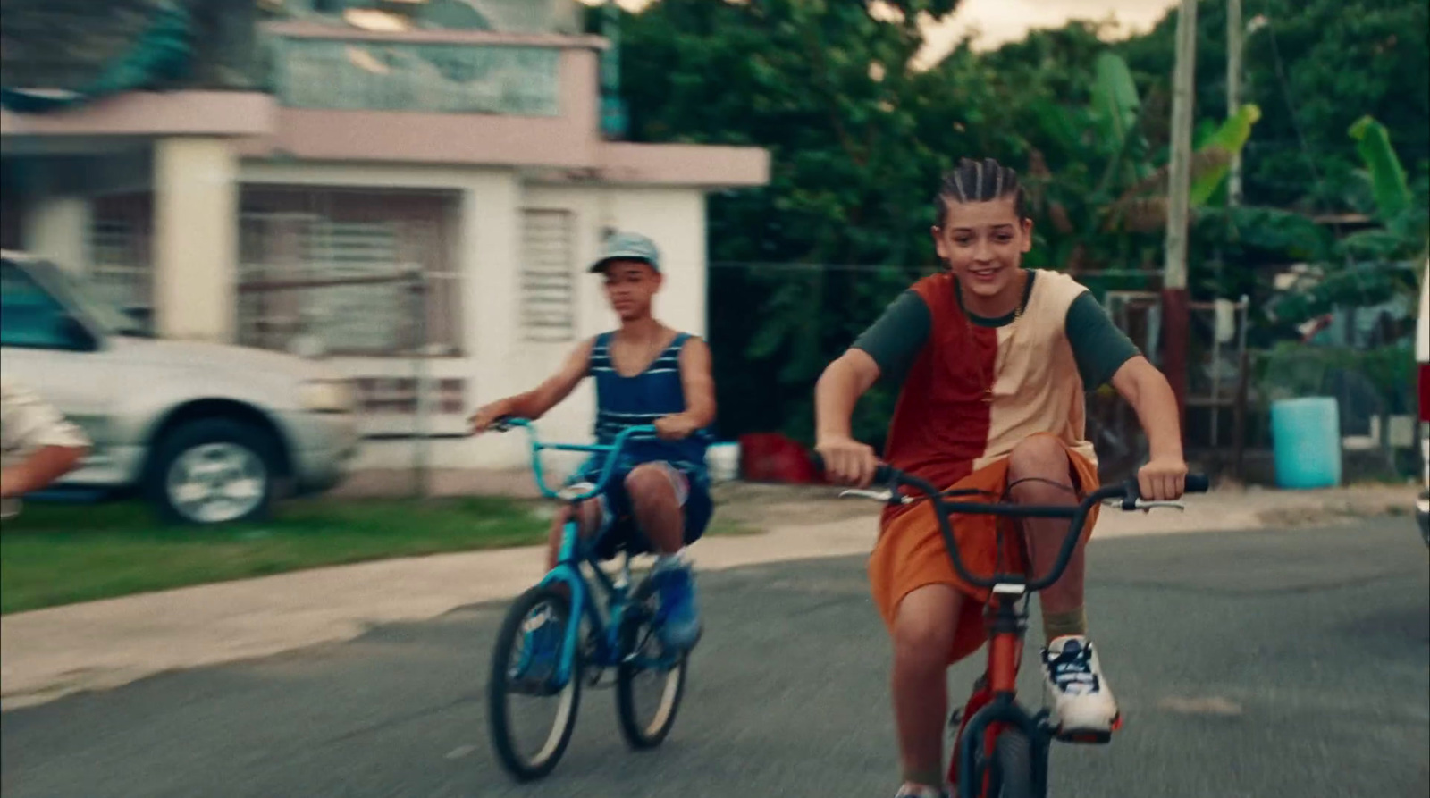 a couple of people riding bikes down a street