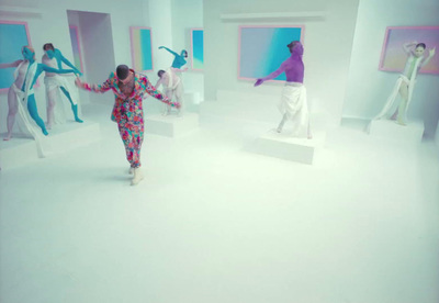 a woman is walking through a white room