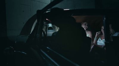 a woman sitting in a car talking on a cell phone