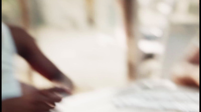 a blurry photo of a person typing on a keyboard