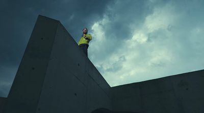 a man standing on top of a cement wall