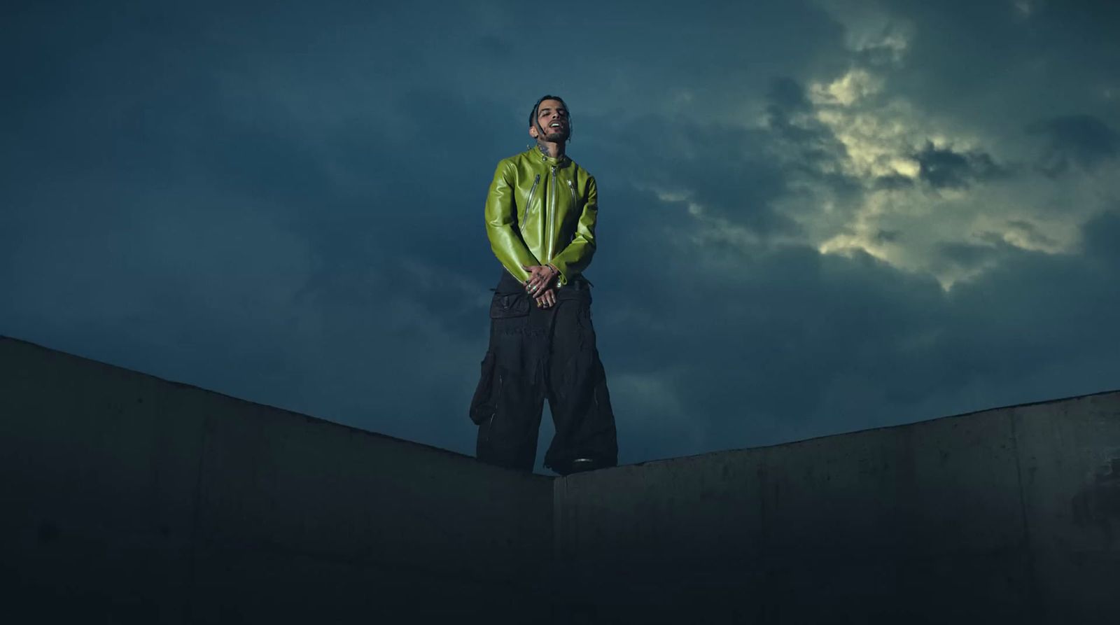 a man standing on top of a cement wall