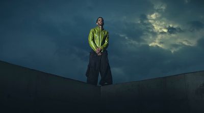 a man standing on top of a cement wall