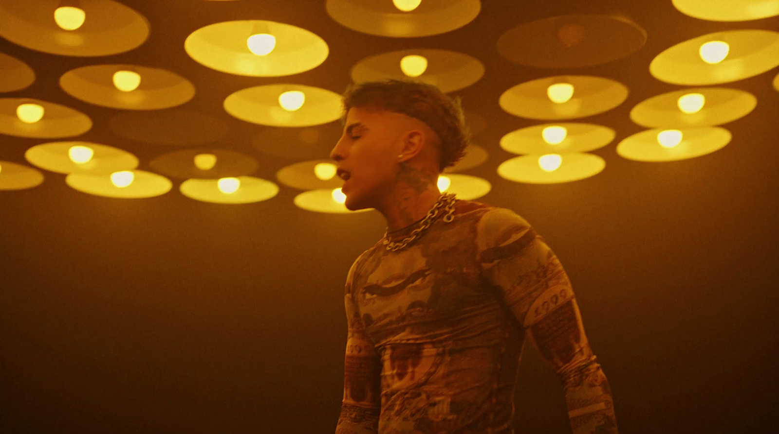 a woman standing in front of a ceiling of lights