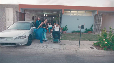 a group of people standing in front of a car