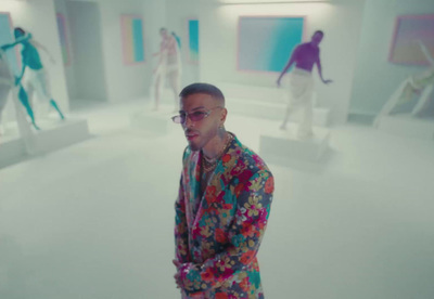 a man in a colorful suit standing in a room