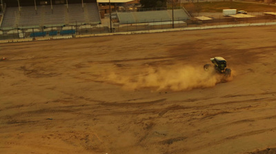 a person riding a vehicle on a dirt track