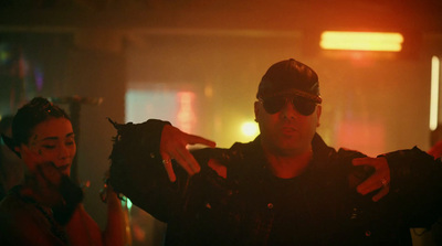 a man in a leather jacket holding a pair of sunglasses