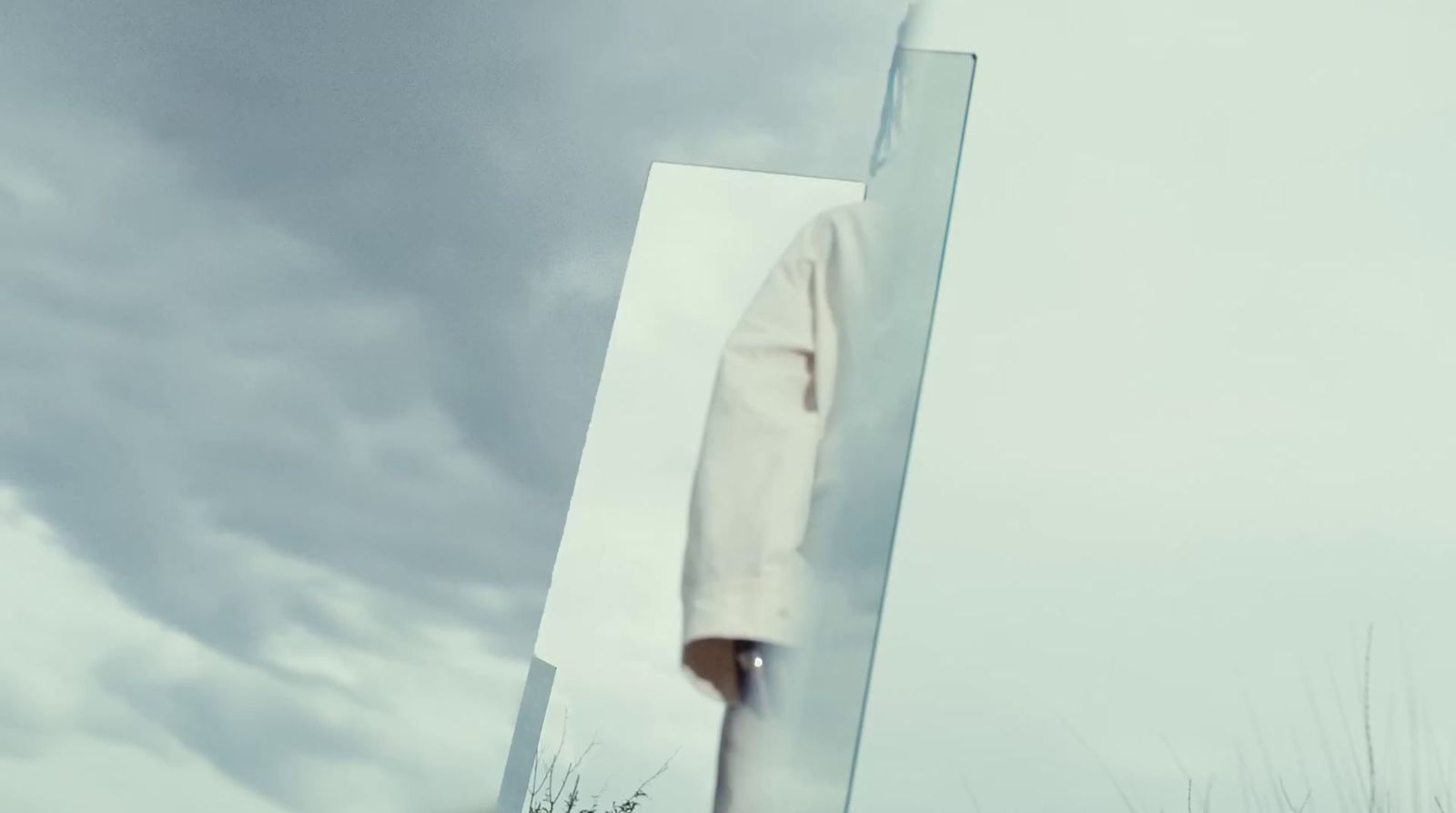 a person standing in front of a large mirror