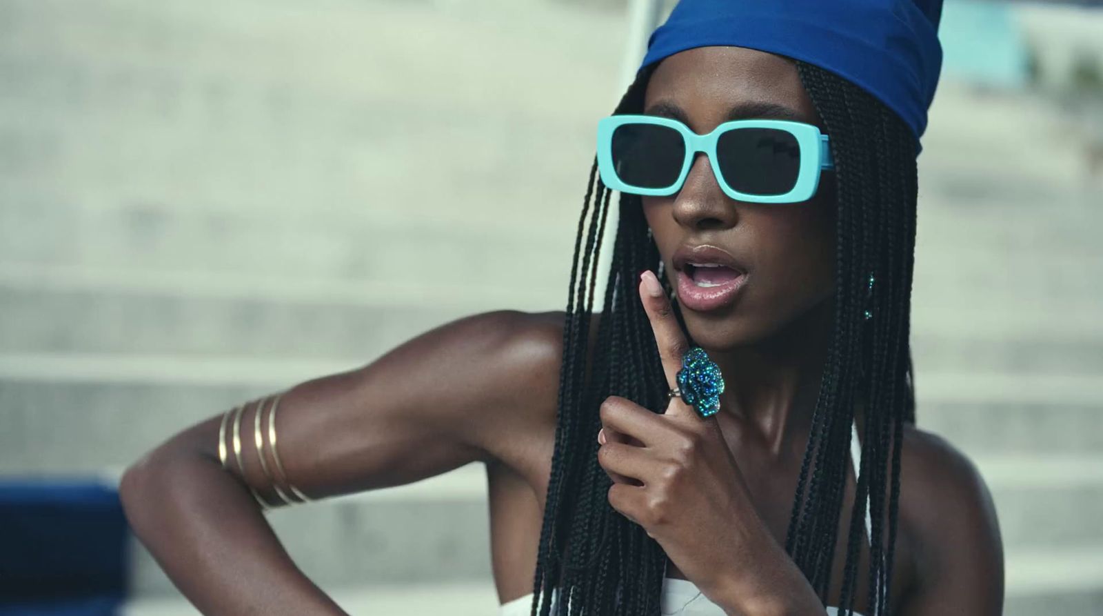 a woman wearing sunglasses and a blue hat