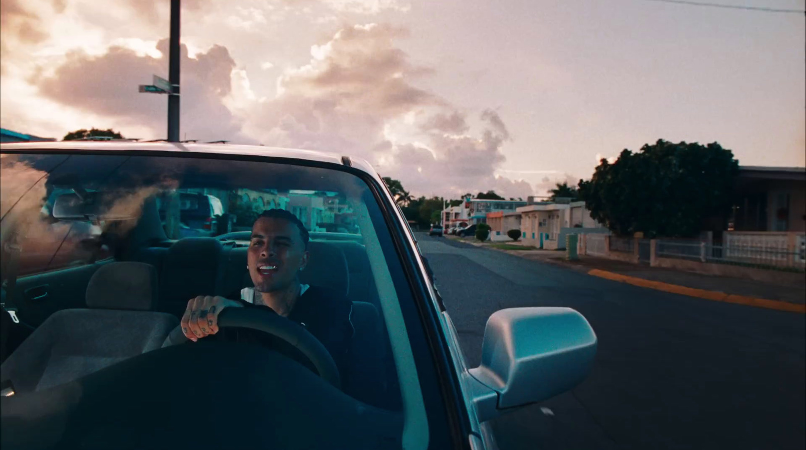 a man driving a car down a street