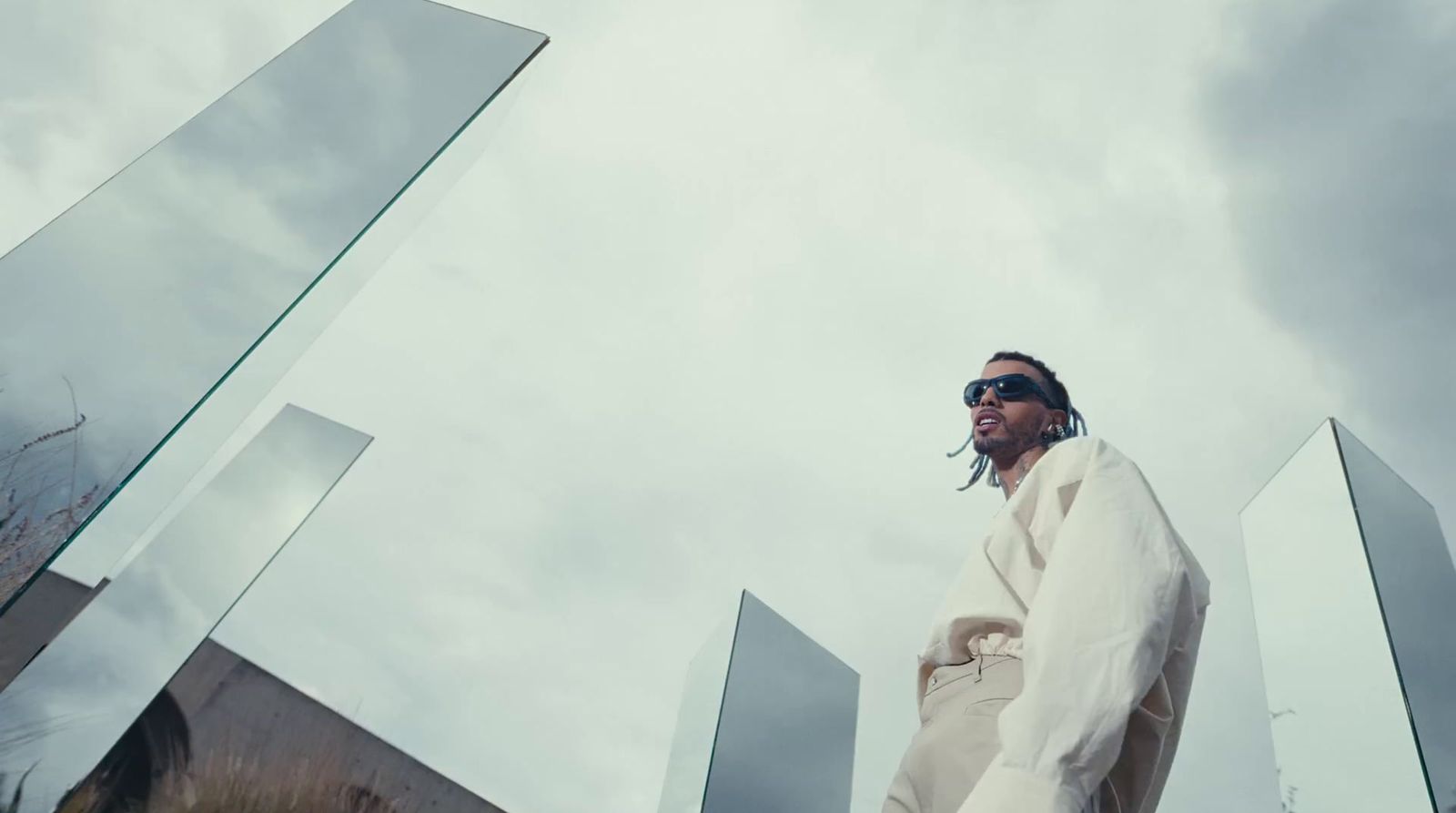 a man in a white suit and sunglasses