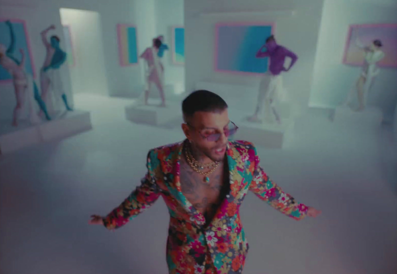 a man in a brightly colored suit is dancing