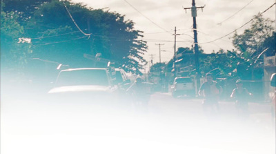 a group of people walking down a street next to a car