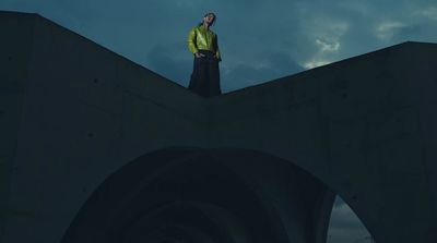 a man standing on the edge of a bridge