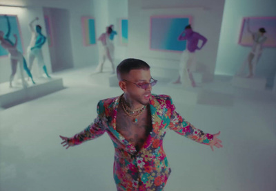 a man in a colorful suit is dancing