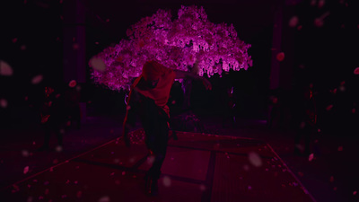 a woman standing under a pink tree in the dark