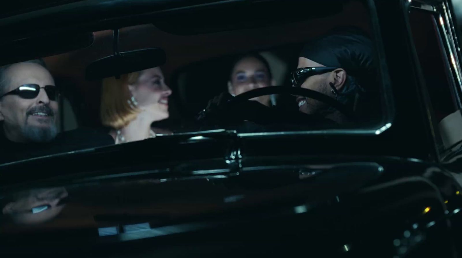 a group of people sitting in a car in the dark