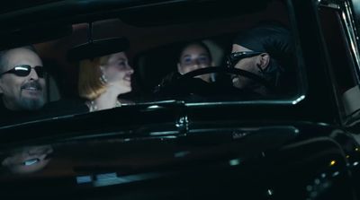 a group of people sitting in a car in the dark