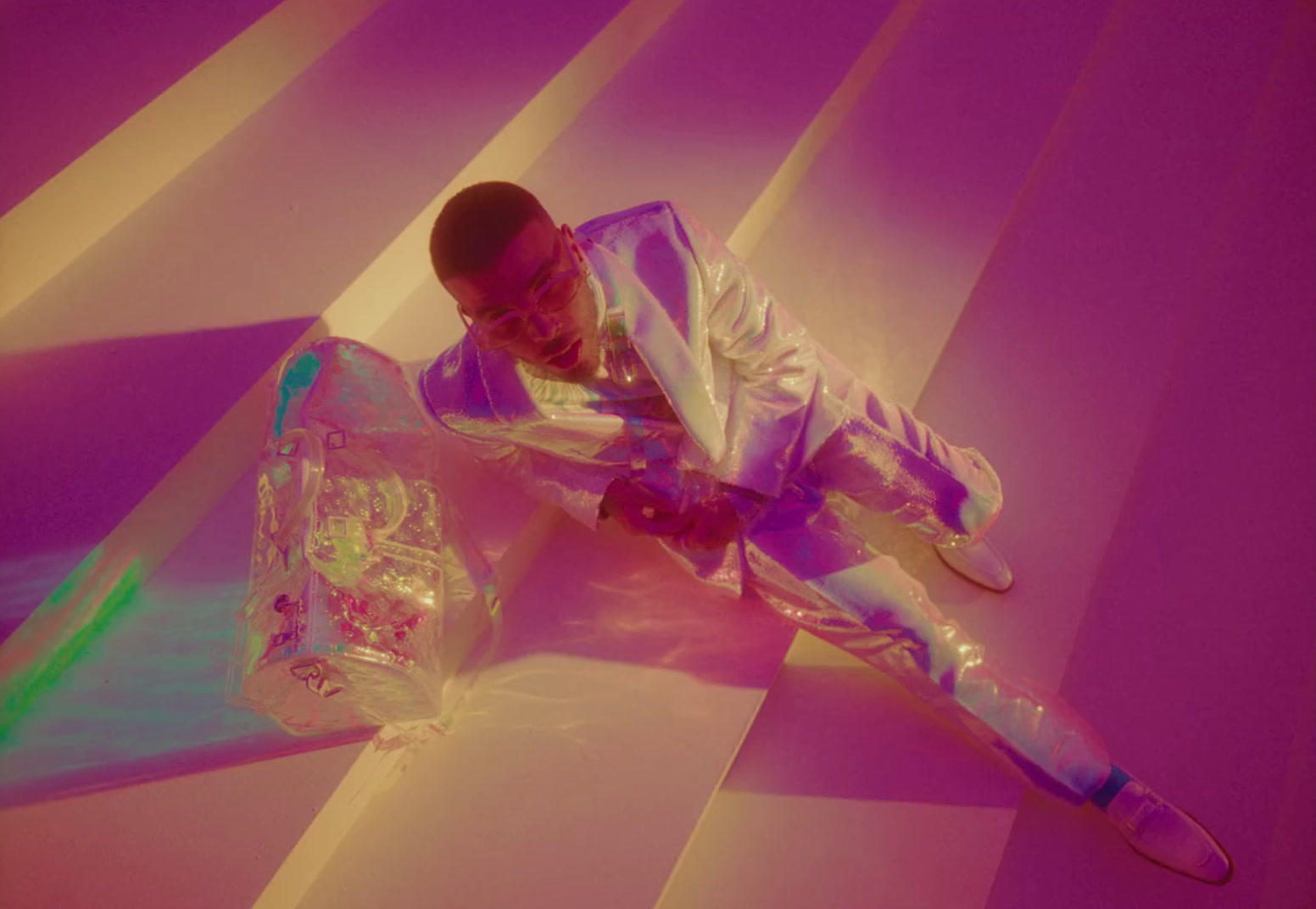 a man in a shiny suit laying on the ground