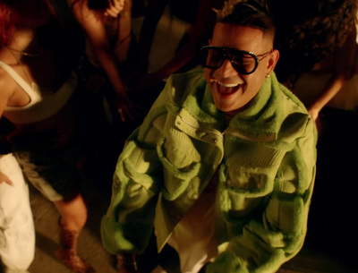 a man wearing a green jacket and sunglasses