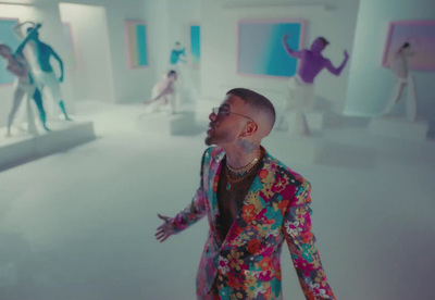 a man in a colorful suit standing in a room