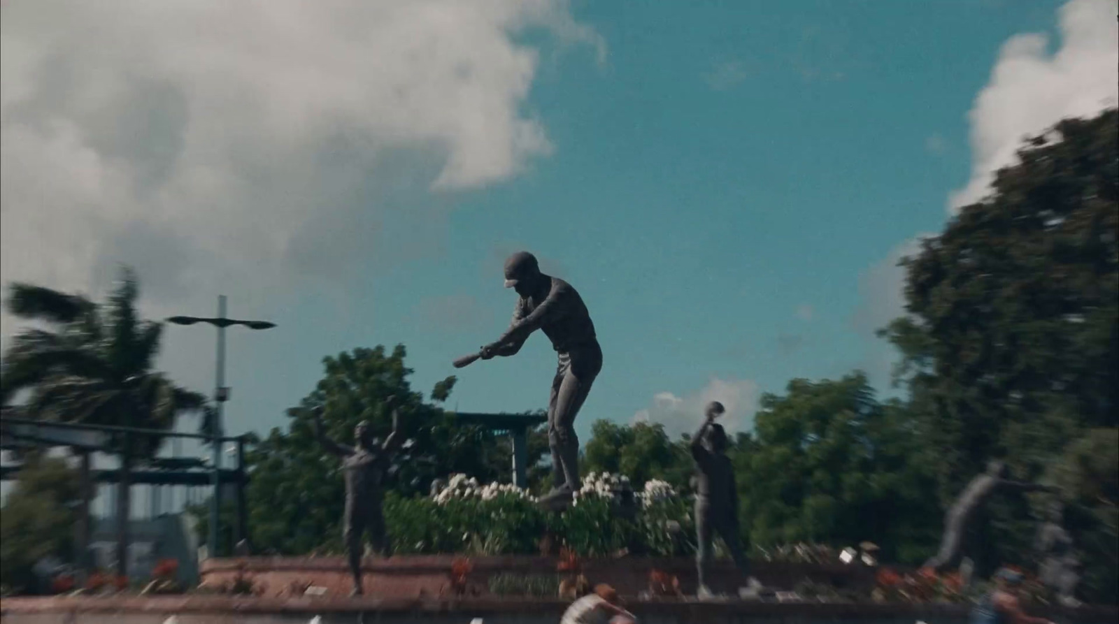 a statue of a man holding a baseball bat