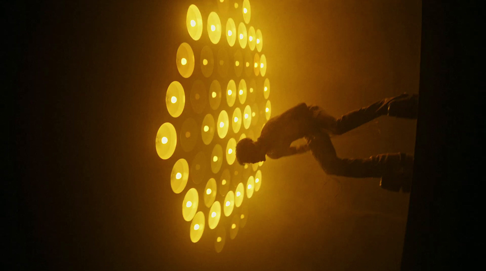 a person holding a cell phone in front of a wall