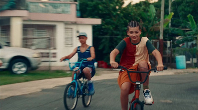 a couple of people riding bikes down a street