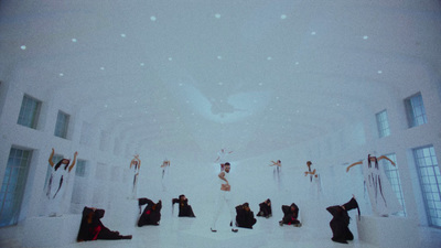 a group of people standing in a white room