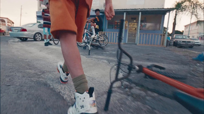 a man riding a skateboard down a street