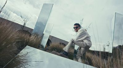 a man standing in front of a large mirror