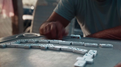 a man playing a game of dominos on a table