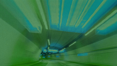 a blurry photo of a tunnel with blue and green lights