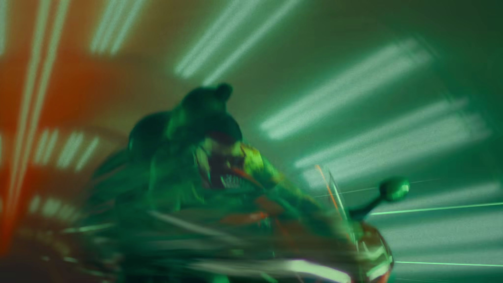 a blurry image of a man riding a motorcycle