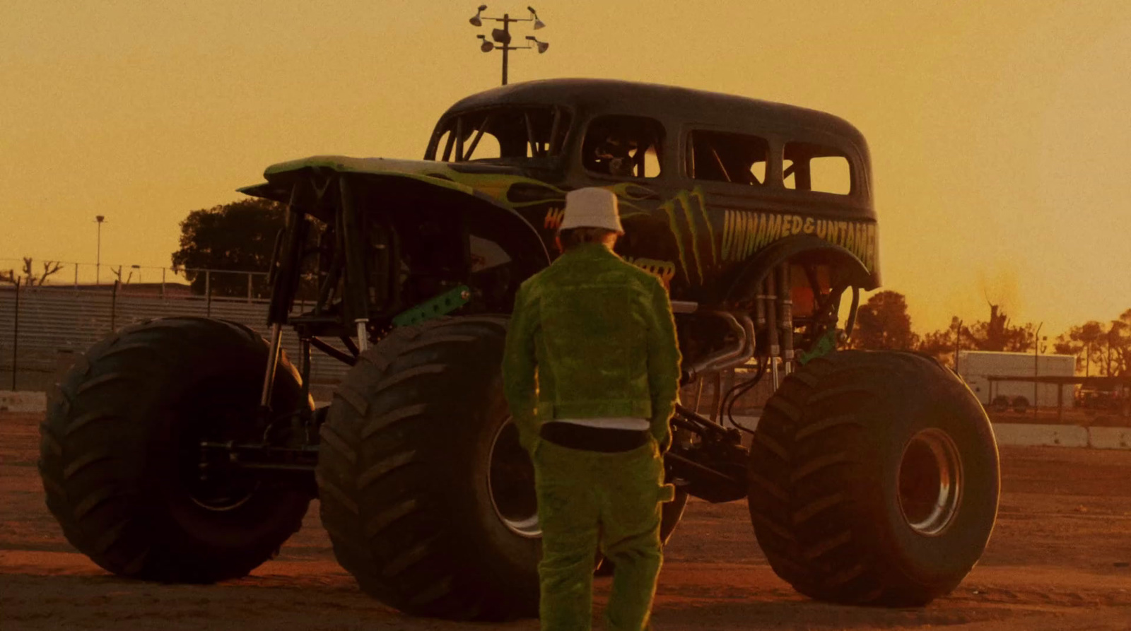 a man standing in front of a monster truck