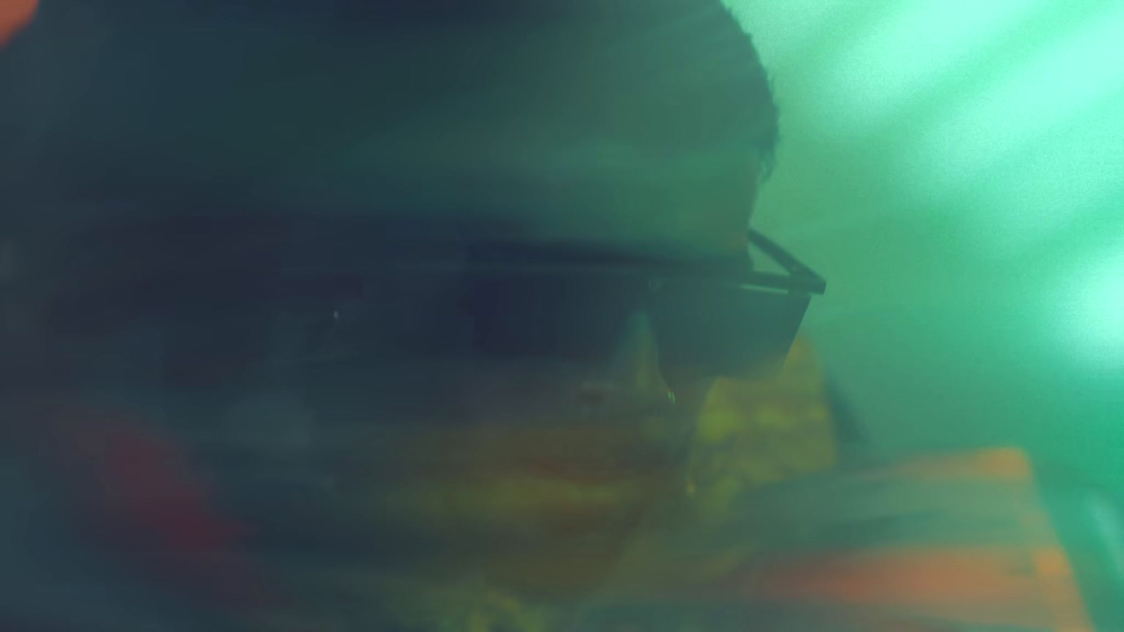 a blurry photo of a man wearing sunglasses