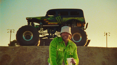 a man standing in front of a monster truck